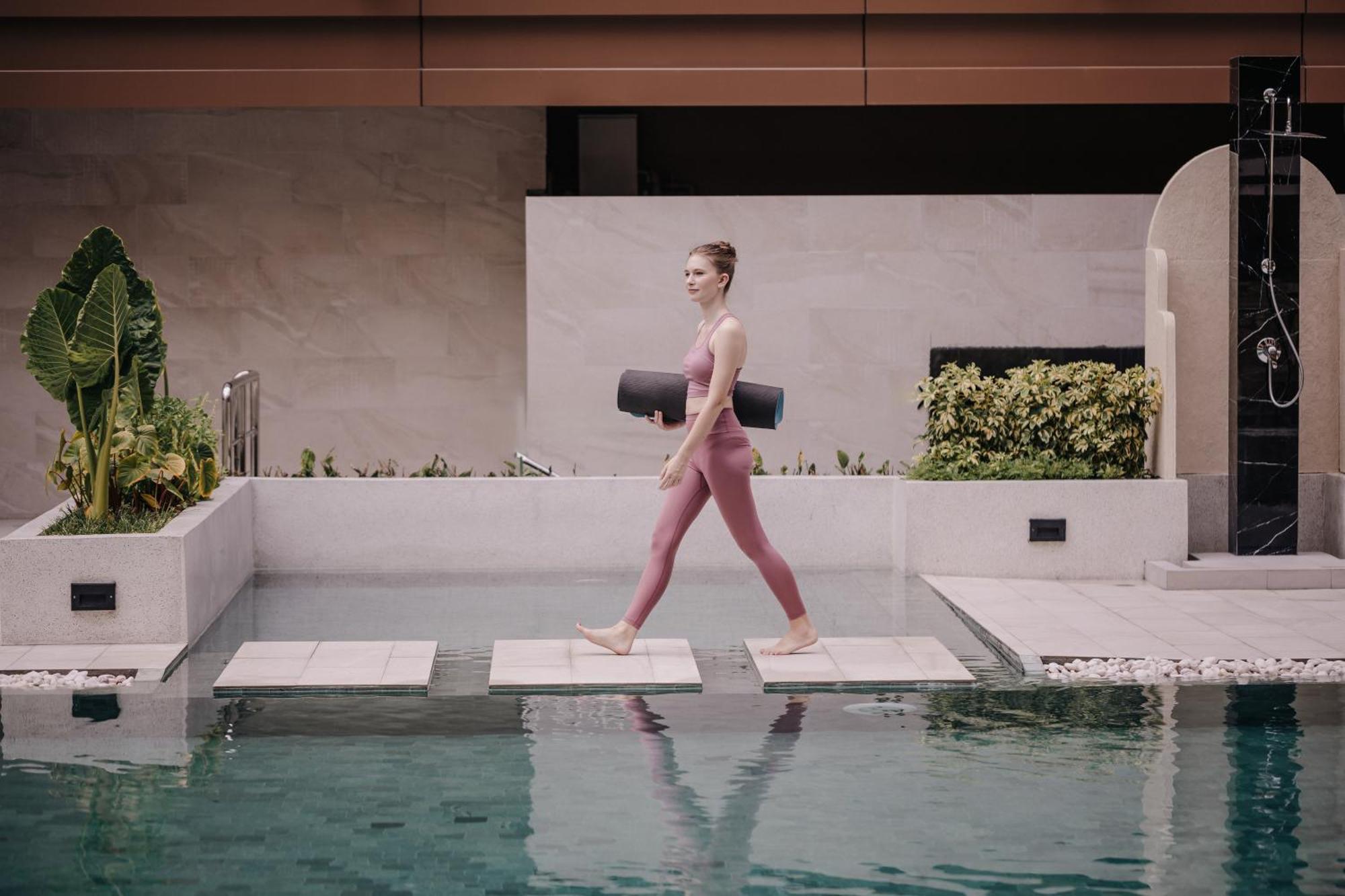 Nysa Hotel Bangkok Sukhumvit 11 Exteriör bild A woman walking on a stepping stone